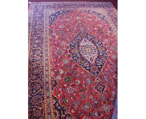 A fine Central Persian Kashan carpet, 325cm x 215cm, central Horal medallion on a rouge field within stylised floral border 