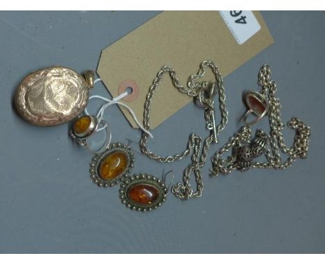 A yellow metal locket, having embossed decoration (a/f), together with two white metal and faux amber rings, two white metal 