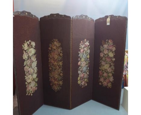 An 19th century Japanese carved hardwood four fold dressing screen, with later tapestry panels. 