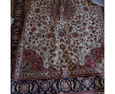 A Kashan style carpet, with central floral medallion, on a beige ground, contained by floral borders. 280 x 200cm 