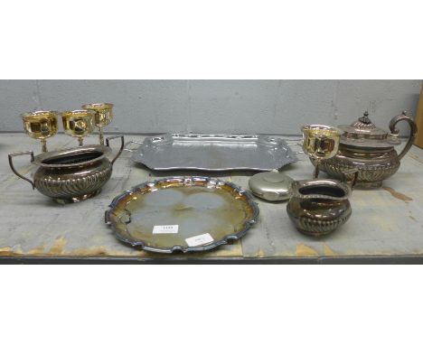 A collection of plated ware including trays, goblets, a three piece tea service and a pewter hip flask **PLEASE NOTE THIS LOT