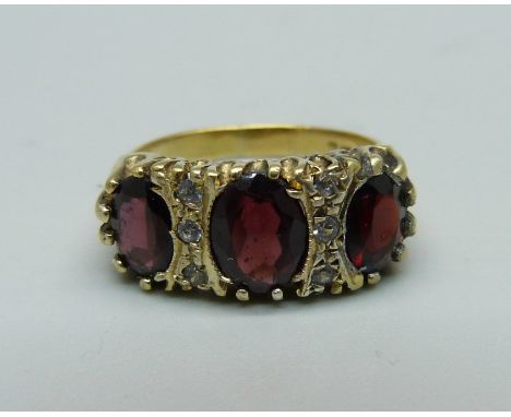 A silver gilt and garnet ring, P 