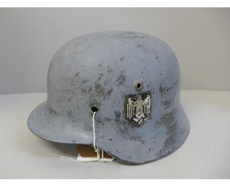 A German WWII M35 helmet shell with post war paint and decal 