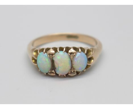 A 9ct gold and three stone opal ring, centre stone chipped, 4.1g, R 