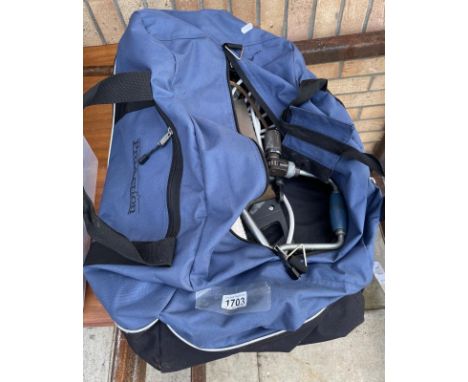 A holdall with tools including saws &amp; a hand drill