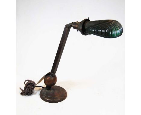 An early 20th century adjustable copper desk lamp, with shaped green overlaid glass shade, height approx 45cm 