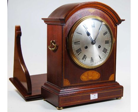 An early 20th century inlaid mahogany cased bracket clock, the silvered dial showing Roman numerals, 8-day movement, standing