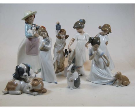 A collection of Nao porcelain ornaments to include children, puppies, and rabbit (8)Condition report: No apparent faults.