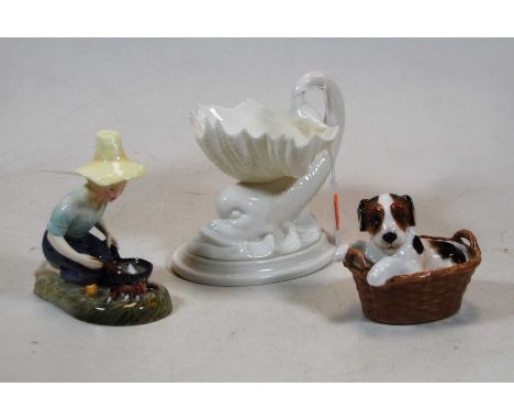 A Royal Worcester blanc-de-chine porcelain Dolphinium table salt; together with a Royal Doulton Playful Puppy No.2587; and a 