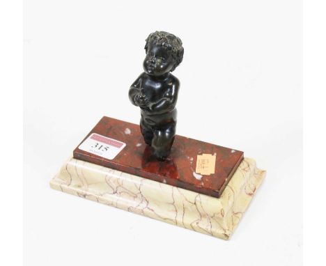 A small bronze figure of a cherub, in kneeling pose on a rouge and veined marble stepped plinth base, h.14cm