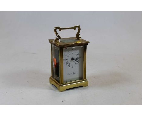 A 20th century lacquered brass cased carriage clock, having an enamelled dial with Roman numerals, signed Charles Frodsham En