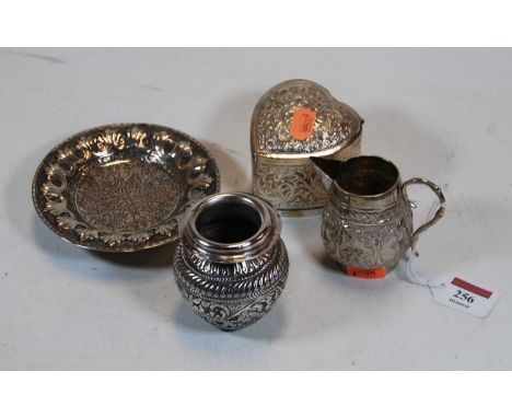 Eastern and Indian white metalwares. to include cream jug, heart shaped trinket box, baluster vase, and a footed bonbon dish,