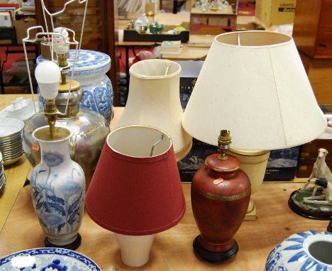 A 20th century porcelain table lamp of baluster form, decorated with flowers, height 60cm including fittings, together with f