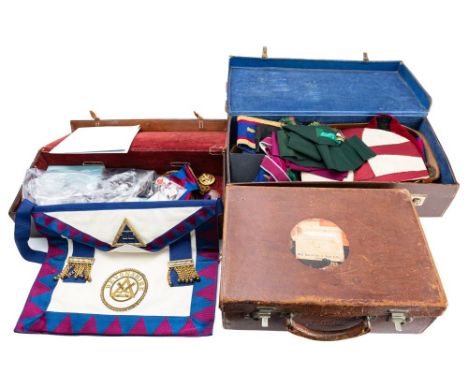 A small group of Masonic Regalia, comprising  sash and apron , together with three jewels in a brown leather case.