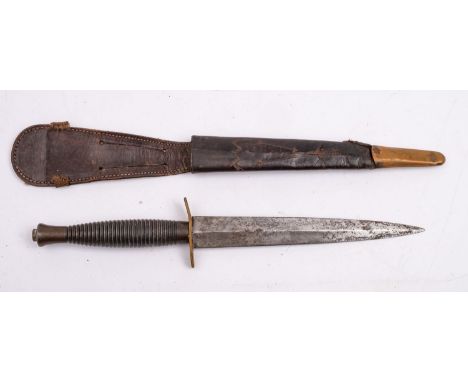 A Fairbairn Sykes Third Pattern Fighting knife,  the straight double edged blade over an oval hilt and cast ribbed grip, in a