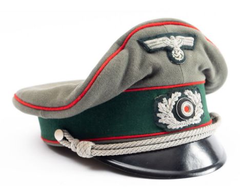 A German Army Artillery Officers Cap, green with red piping and black peak, silver cord, lining  torn. 