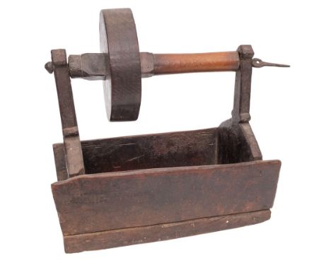 A rare wood toasting dog with single iron prong, turned wheel and rectangular trough, 18th/19th Century.