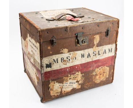 Four pairs of Indian chappal or jutti shoes, together with four pith helmets in a canvas trunk.