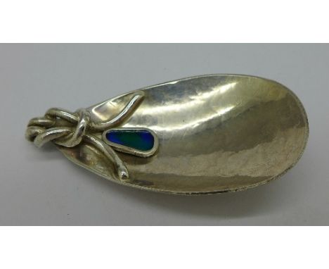 A modern silver Art and Crafts style caddy spoon