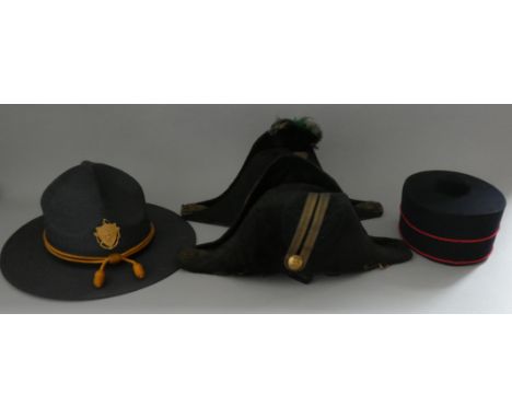 A QUANTITY OF HEADDRESScomprising a Victorian black silk bicorn hat of the Army Pay Department (lining and headband partly de