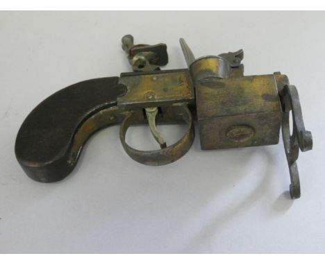 A TABLE LIGHTER BASED ON AN 18TH CENTURY TINDER LIGHTER BY DUNHILL, 20TH CENTURY; inscribed ~Dunhill Tinder Pistol made in En