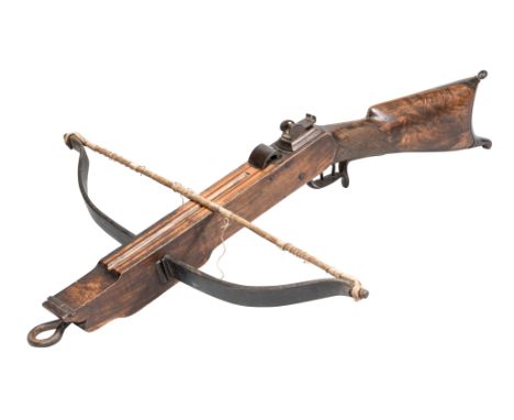 A NORTH EUROPEAN CROSSBOW, LATE 19TH CENTURY; with robust steel bow fitted with a string of twisted cords, shaped wooden till