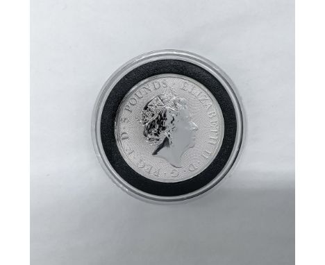 The obverse side of the coin features the profile of Queen Elizabeth II. The reverse side features a falcon clutching a shiel