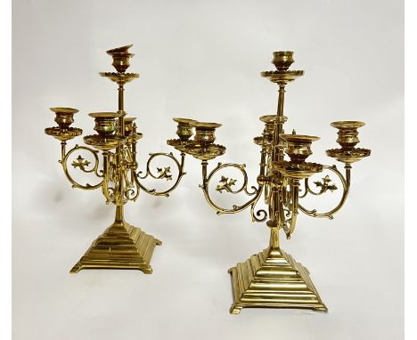 A pair of heavy ornate four branch brass candelabra (h. 35cm) together with a set of ten green candles