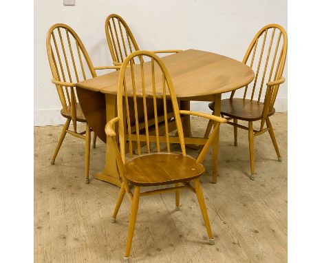 An Ercol elm gate leg dining table, with shaped drop flaps, 72cm x 140cm x 128cm, together with a set of four Ercol Quaker el
