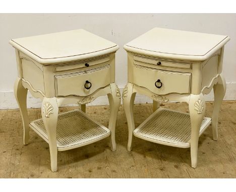 A pair of John Lewis bedside tables, with a moulded top above a pull out shelf and drawer below, standing on shaped supports 