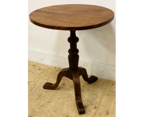 A teak occasional table, with a circular top on a turned column and tripod base, 66.5cm x 56.5cm 