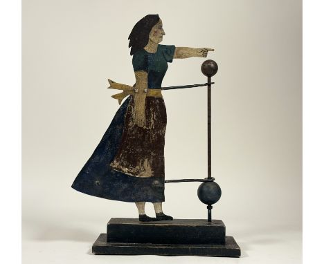 A Ramsay Gillies contemporary Folk Art inspired weather vane with painted sheet metal of a woman pointing, on a raised steppe