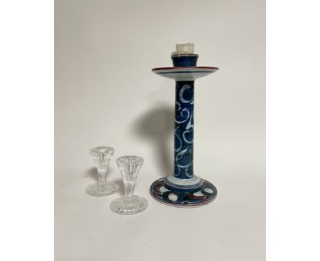 A tall handpainted ceramic glazed candlestick decorated with blue and red scrolls (h. 23cm) (signed verso) together with a pa