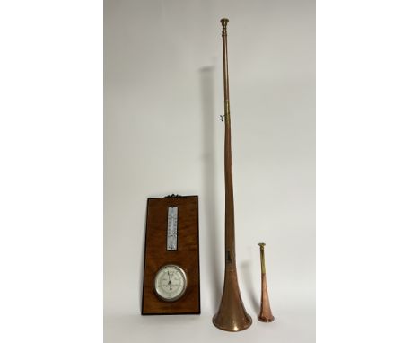 A German manufactured ship's barometer with additional thermometer mounted on a wooden panel with inlaid border and brass wal