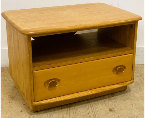 An Ercol elm side table, with a rectangular top with a triangular drop flap above an open shelf with a drawer below, standing