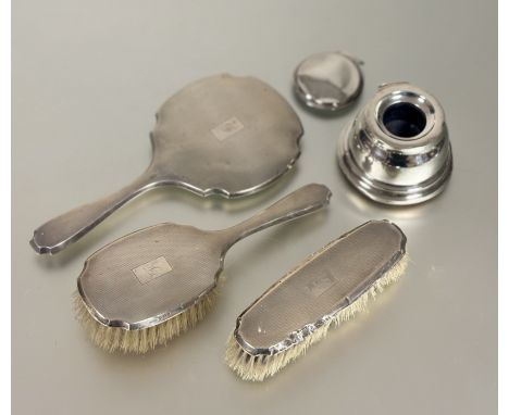 An Edwardian Birmingham silver three-piece brush set with engine-turned decoration and engraved initial F to include hair bru
