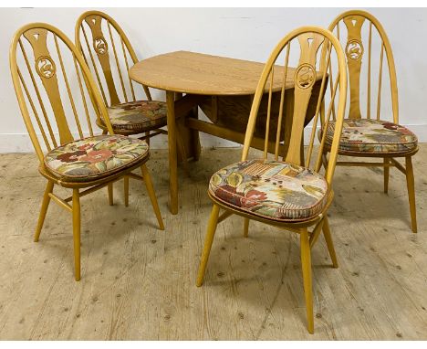 An Ercol elm gateleg dining table, with shaped drop flaps and shaped turned supports, 73cm x 122cm x 107cm, together with fou