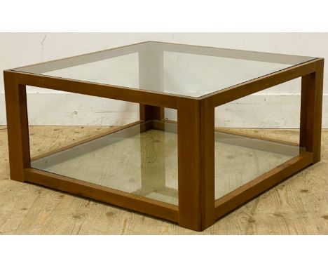 A teak occasional table, with an inset glass top above a glass shelf, 36cm x 75.5cm x 75.5cm 
