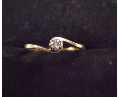 A 9ct gold crossover ring set solitaire diamond 