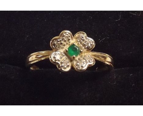 An emerald and chip diamond cluster ring 