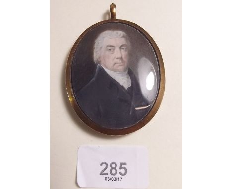 A Victorian miniature portrait of a gentleman in yellow metal and enamel frame with hair locket to verso with inscription 'Sa