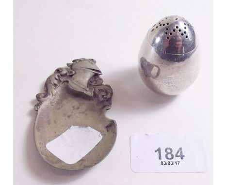 A silver continental caddy spoon with cavalier helmet and scrollwork handle - Chester 1899 and a silver egg form pepper pot -