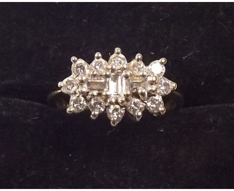 An 18 carat gold ring set baguette and brilliant cut diamonds