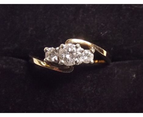 A three stone diamond crossover ring 