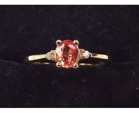 A padparadscha sapphire and gold ring 