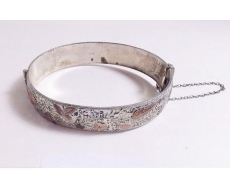 A silver engraved hinged bangle applied rose gold foliage, bird and insect