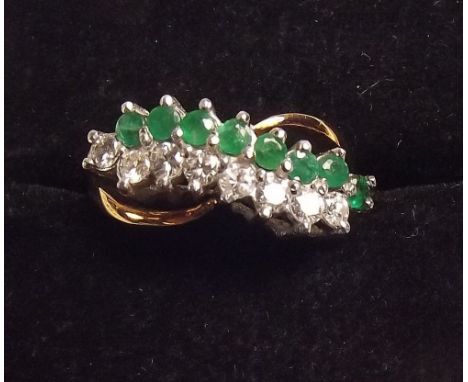 An 18ct gold diamond and emerald ring