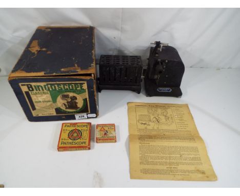 A vintage c. 1920's Pathescope Bingoscope home cinema projector in original box including two 9.5 mm films (one of Mickey Mou