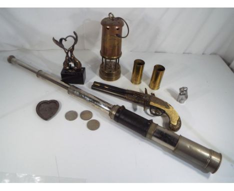 A good mixed lot to include two Eley London brass cartridges (trench art) a British coal miners lamp, white metal vintage tel