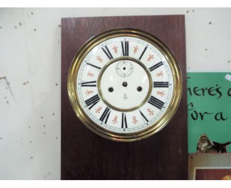 A Gustav Becker twin weight movement, dial and pendulum only, mounted on a board for display/ use, white two-piece enamel dia